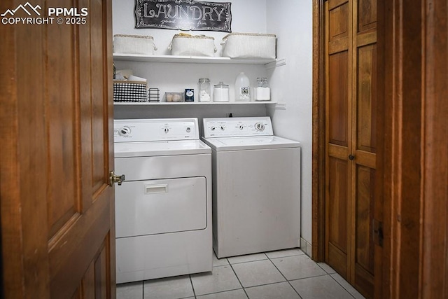 laundry area with laundry area, light tile patterned floors, and separate washer and dryer