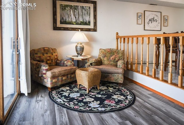 sitting room featuring wood finished floors and visible vents