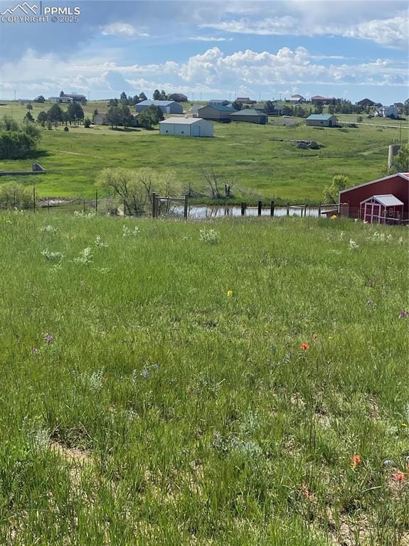 view of yard featuring a rural view and a water view