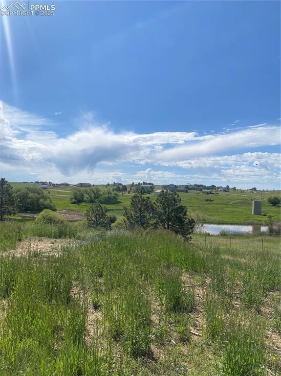 view of local wilderness featuring a water view and a rural view