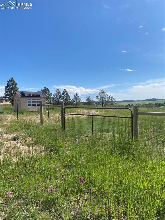 view of yard featuring a rural view and fence