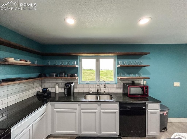 kitchen with black dishwasher, open shelves, dark countertops, white cabinets, and a sink