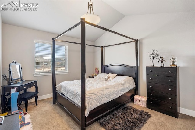 carpeted bedroom with vaulted ceiling and baseboards