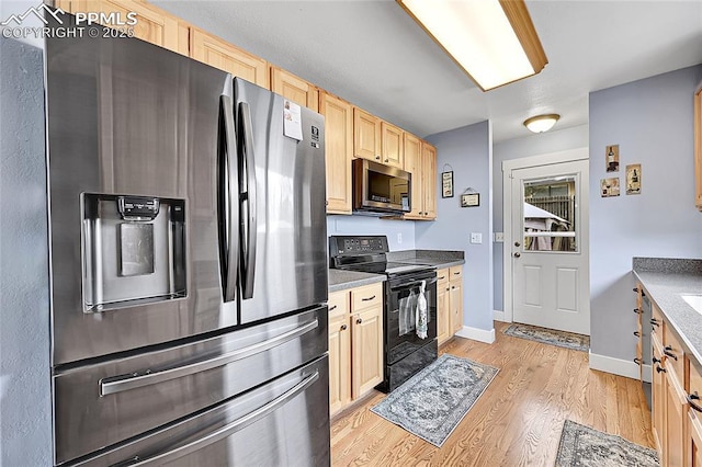 kitchen with light wood-type flooring, baseboards, appliances with stainless steel finishes, and light brown cabinets