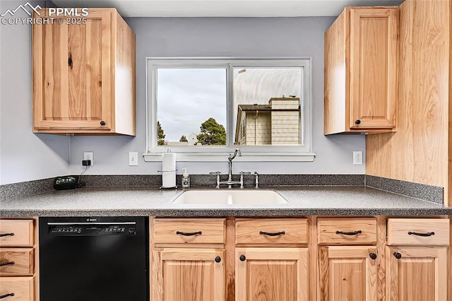 kitchen featuring light brown cabinetry, dark countertops, black dishwasher, and a sink