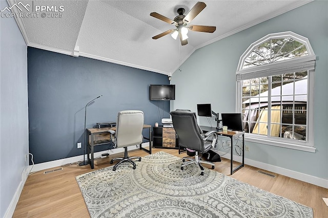 office space featuring visible vents, crown molding, ceiling fan, lofted ceiling, and wood finished floors