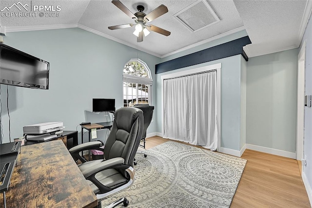 office with a textured ceiling, light wood-type flooring, crown molding, and lofted ceiling