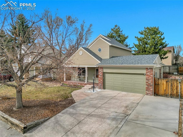 view of front of house with fence, a shingled roof, concrete driveway, a garage, and brick siding