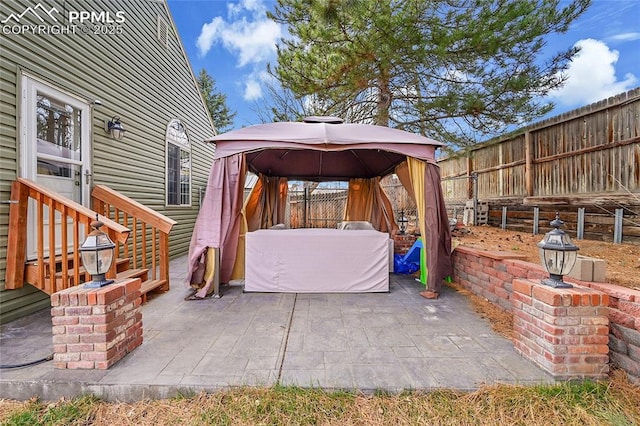 view of patio with a gazebo and a fenced backyard