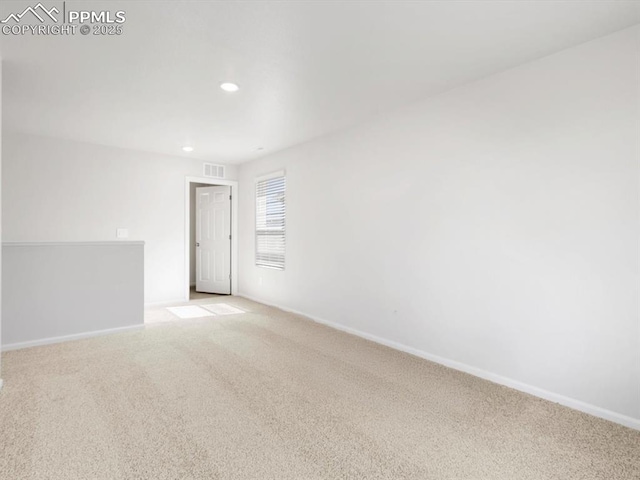 unfurnished room with recessed lighting, visible vents, baseboards, and light carpet