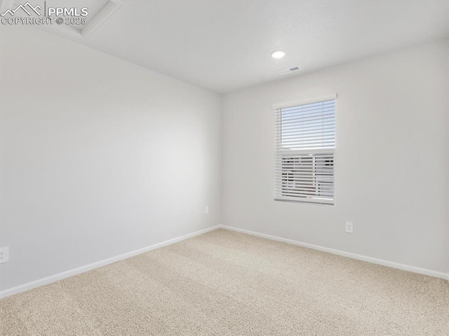 spare room featuring visible vents, carpet flooring, and baseboards