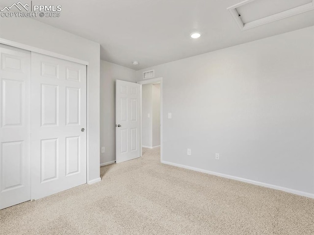 unfurnished bedroom with a closet, carpet, baseboards, visible vents, and recessed lighting