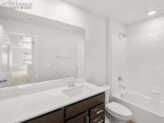bathroom with toilet, vanity, shower / tub combination, and visible vents