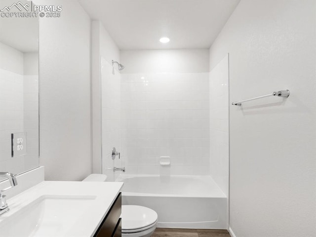 bathroom featuring tub / shower combination, wood finished floors, toilet, and vanity