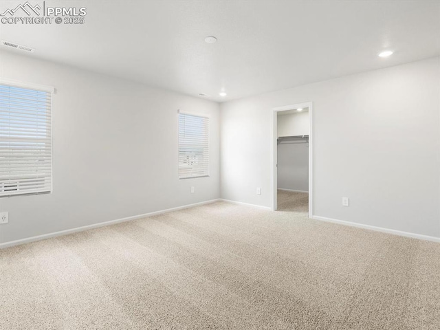 spare room with baseboards, visible vents, carpet, and recessed lighting