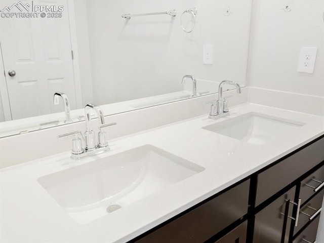 bathroom featuring a sink and double vanity