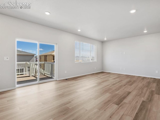 spare room with light wood finished floors, baseboards, and recessed lighting