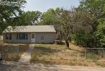 single story home with fence