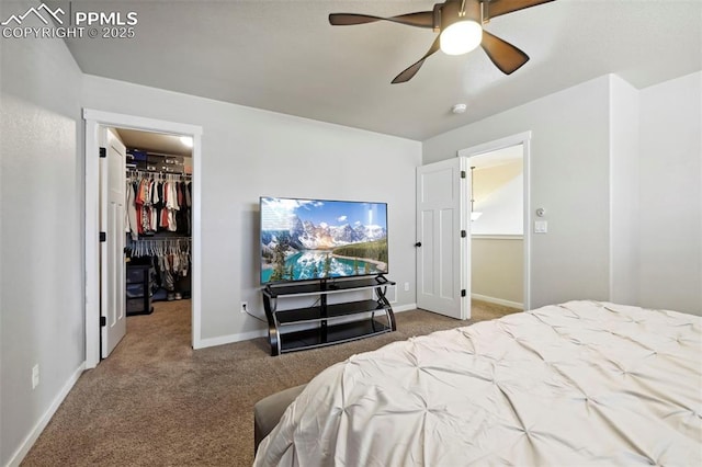 carpeted bedroom featuring a ceiling fan, a spacious closet, baseboards, and a closet