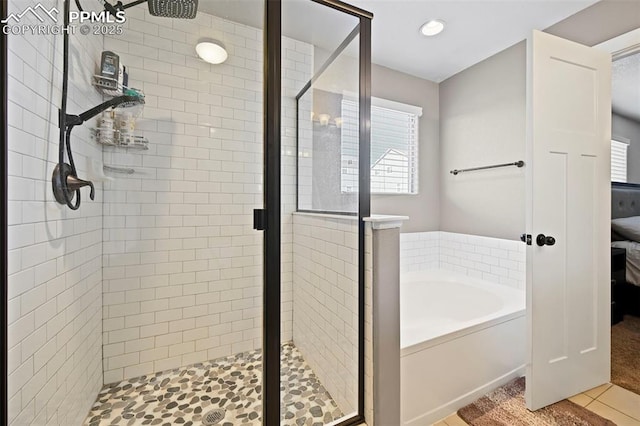 bathroom with a stall shower and a garden tub