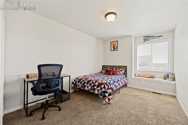 carpeted bedroom with visible vents, baseboards, and a textured ceiling