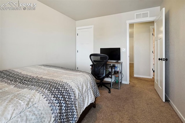 carpeted bedroom featuring visible vents and baseboards