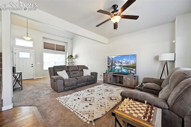 living room with ceiling fan, carpet, and baseboards