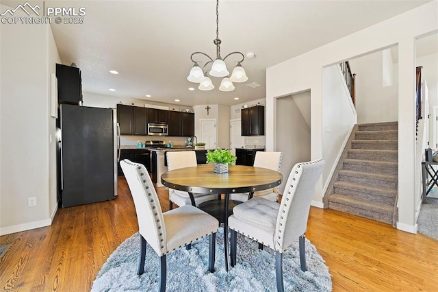 dining space featuring baseboards, stairway, light wood-type flooring, a chandelier, and recessed lighting