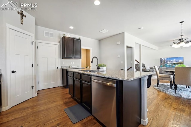 kitchen featuring a sink, visible vents, dishwasher, and wood finished floors