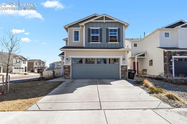 craftsman house featuring an attached garage, stone siding, board and batten siding, and concrete driveway