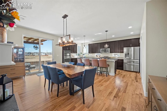 dining area with recessed lighting and light wood finished floors