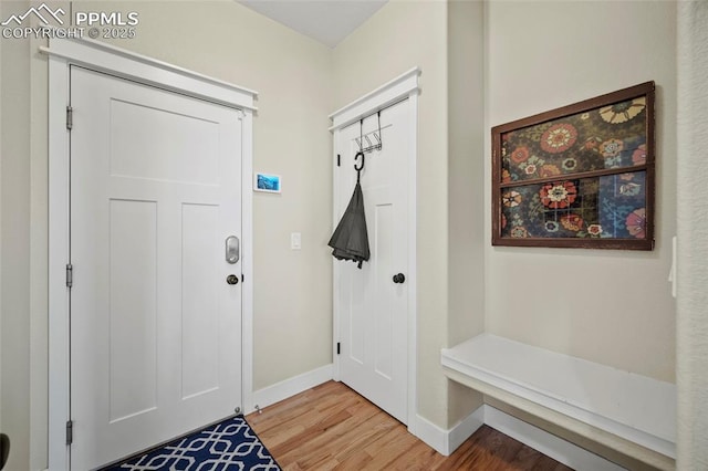 mudroom featuring baseboards and light wood-style flooring