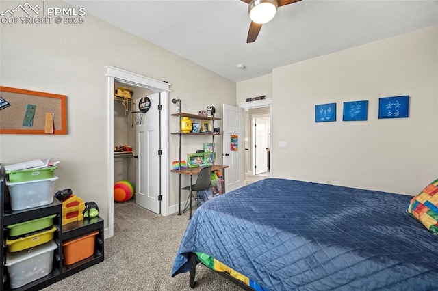 carpeted bedroom featuring a spacious closet and ceiling fan