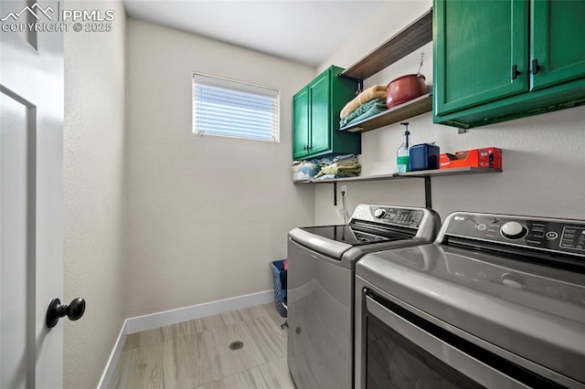 washroom featuring cabinet space, independent washer and dryer, and baseboards