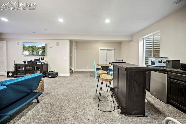 kitchen with dark countertops, baseboards, light carpet, recessed lighting, and fridge