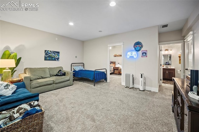 bedroom with visible vents, radiator, connected bathroom, and light colored carpet