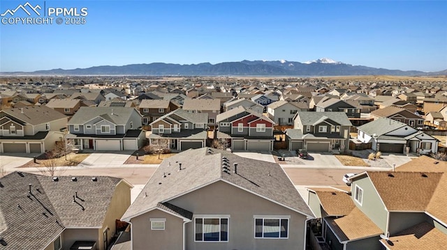 drone / aerial view featuring a residential view and a mountain view