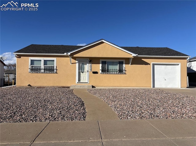 view of front facade featuring roof with shingles, an attached garage, and stucco siding