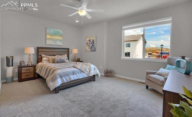 bedroom with baseboards, carpet, and a ceiling fan