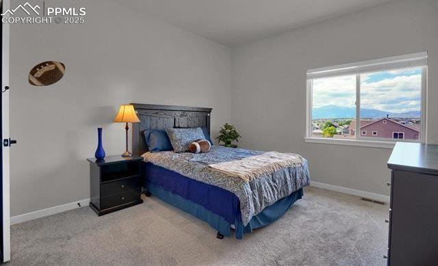 carpeted bedroom featuring visible vents and baseboards