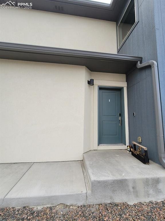 doorway to property with stucco siding