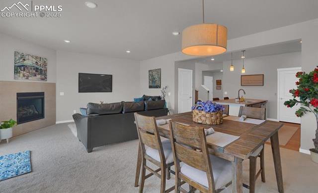 dining space with recessed lighting, baseboards, and a glass covered fireplace