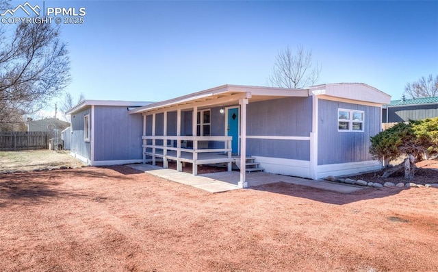 view of front of house featuring fence