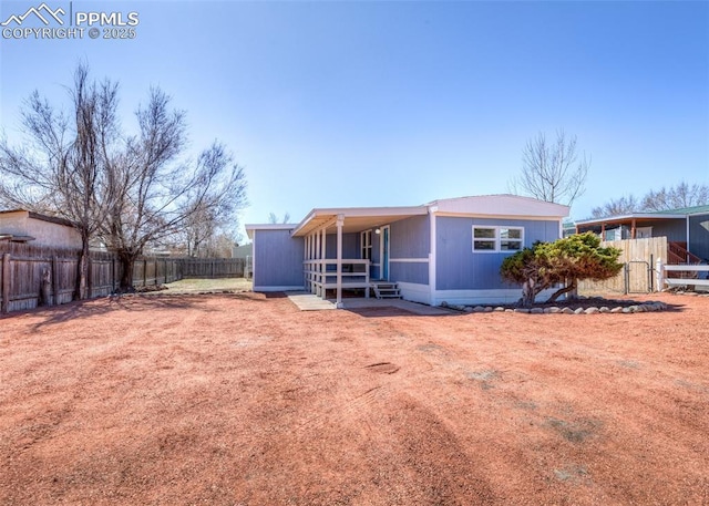 rear view of property featuring an outbuilding