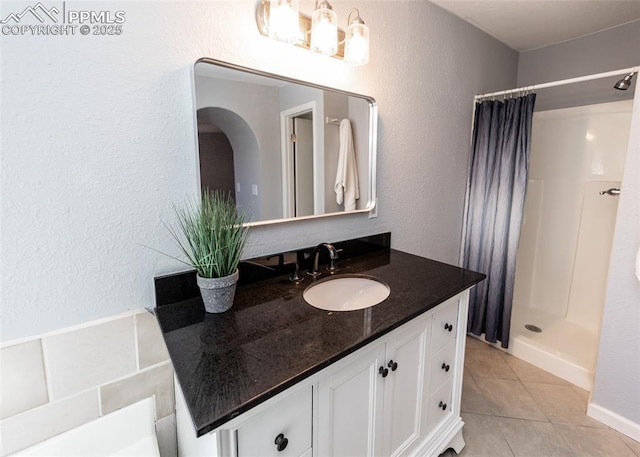 full bathroom featuring a shower stall, vanity, and tile patterned floors