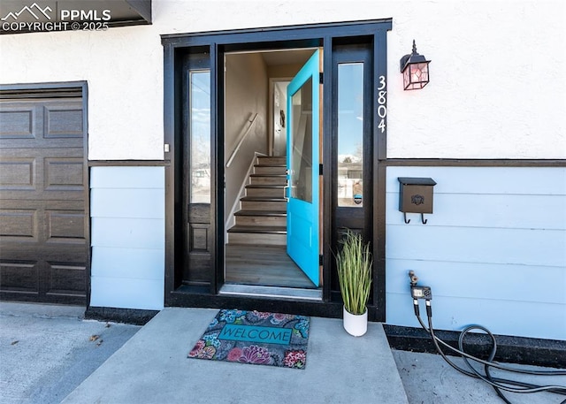 doorway to property with a garage