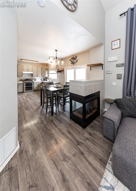 4679 Canyon Wren Ln, Colorado Springs, CO 80916 - living room featuring dark wood-style flooring and a tile fireplace