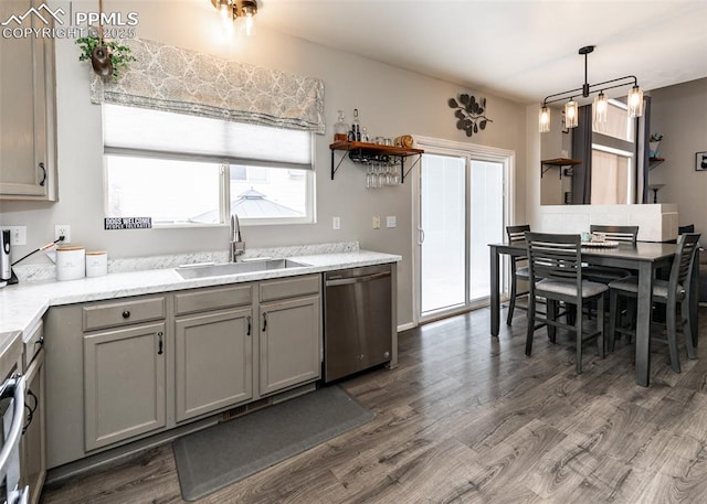 4679 Canyon Wren Ln, Colorado Springs, CO 80916 - kitchen with a sink, stainless steel dishwasher, gray cabinets, dark wood-style flooring, and pendant lighting