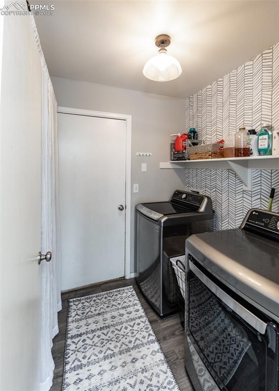 4679 Canyon Wren Ln, Colorado Springs, CO 80916 - washroom featuring washer and clothes dryer and wood finished floors