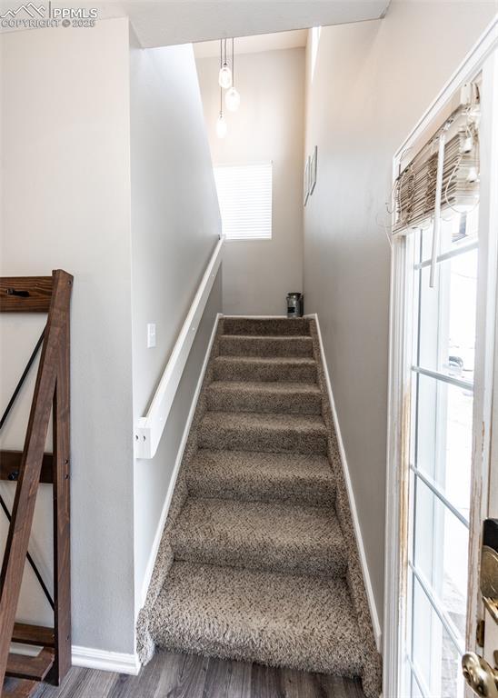 4679 Canyon Wren Ln, Colorado Springs, CO 80916 - stairs featuring wood finished floors and baseboards